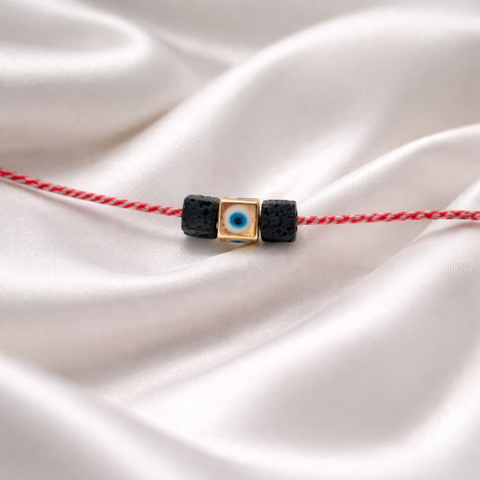 Μαρτάκι με μεταλλικη χάντρα ματάκι και μαύρη πέτρα υφαιστιακή